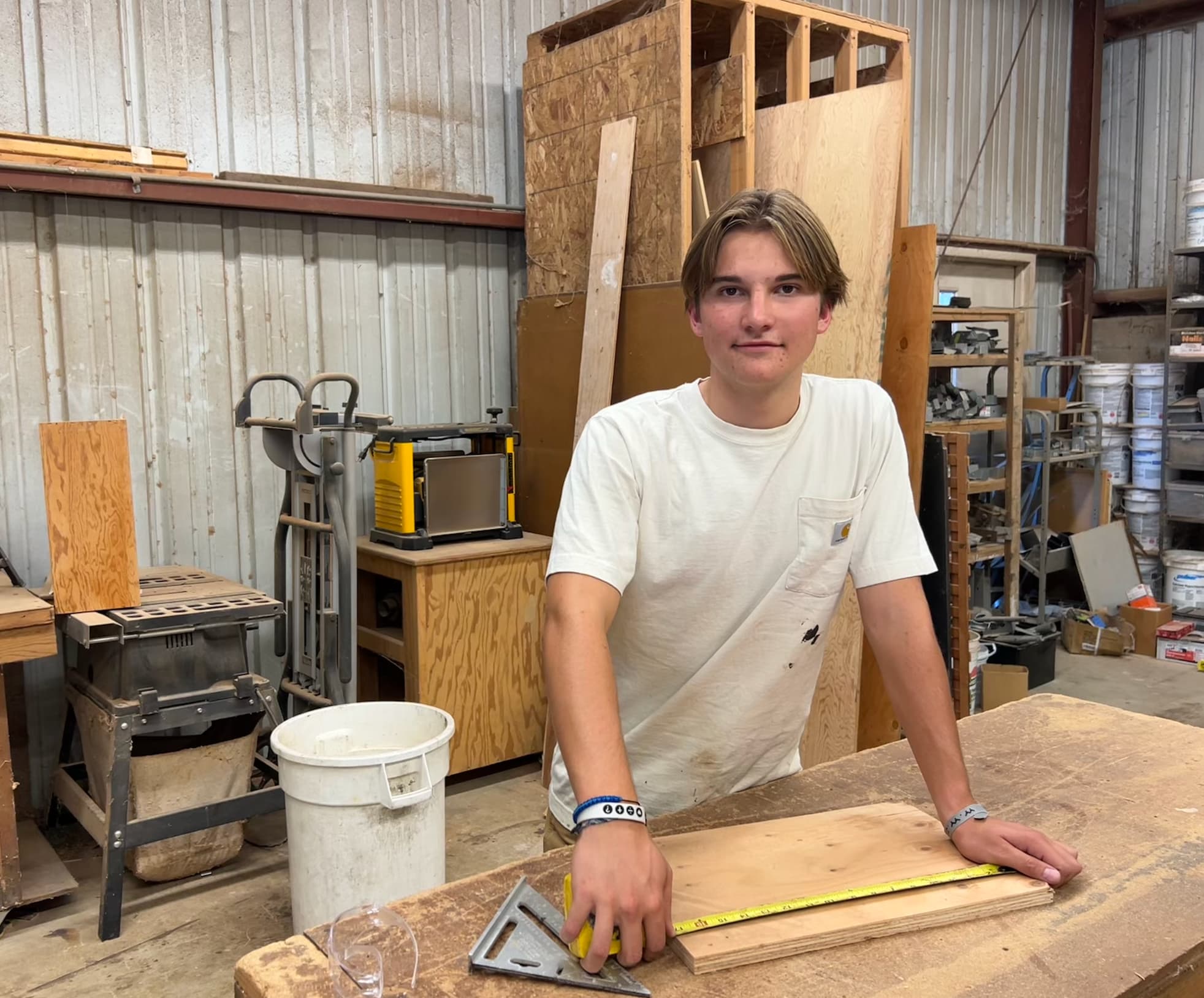 Taylor today, measuring a piece of wood in the workshop